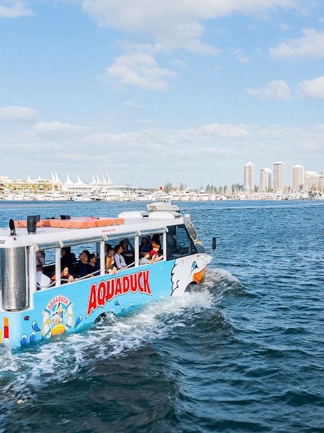 Aquaduck tour boat sailing near Sunshine Coast skyline.