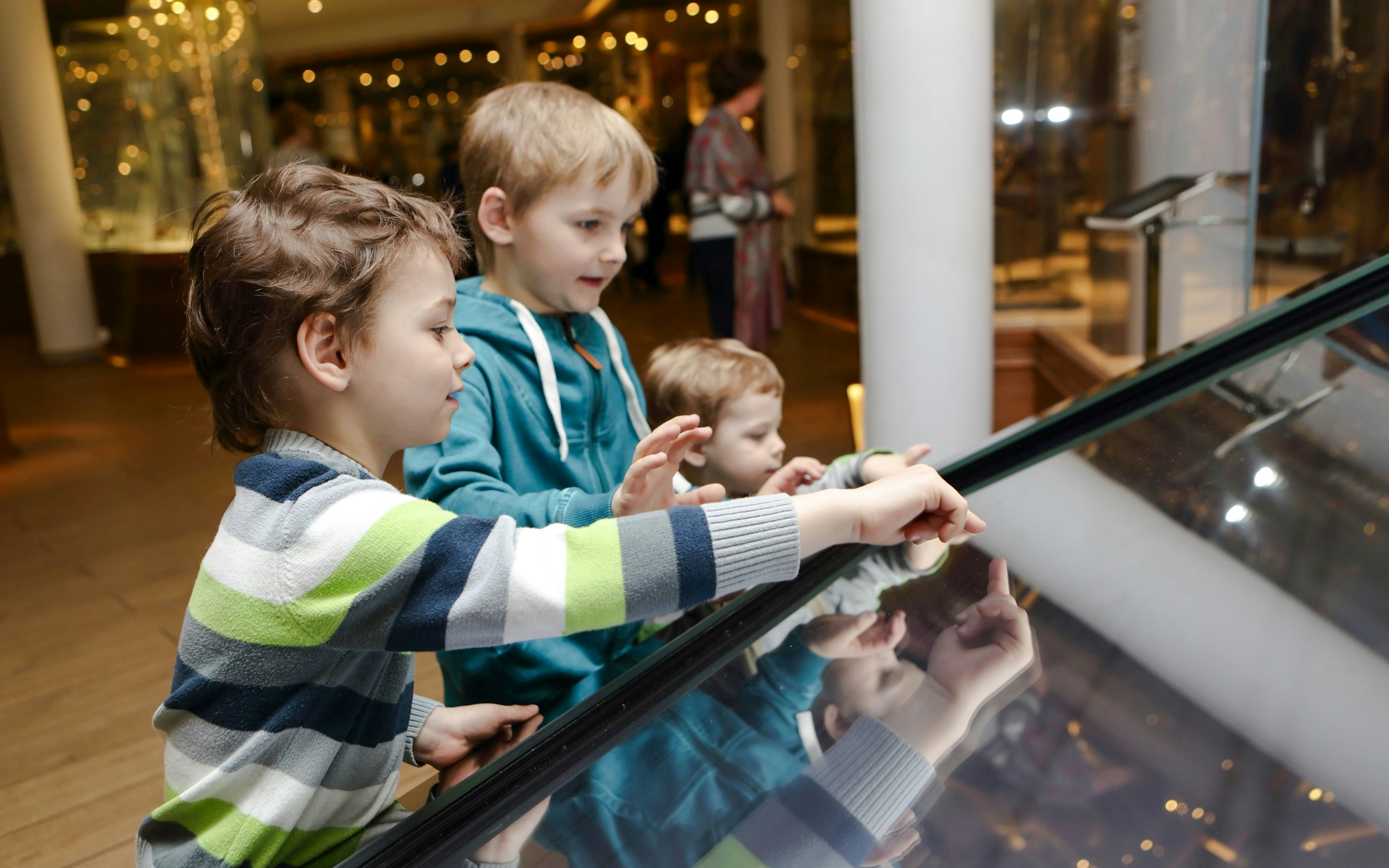 Children interacting with a touchscreen exhibit at Melbourne Museum Scienceworks Sportsworks.
