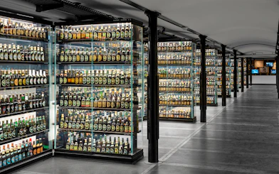 Carlsberg beer bottle collection display inside Home of Carlsberg exhibit.