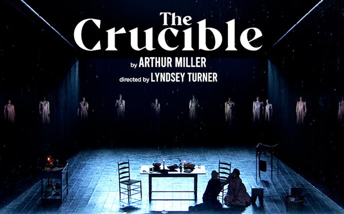 Stage scene from "The Crucible" with table and chairs, directed by Lyndsey Turner.