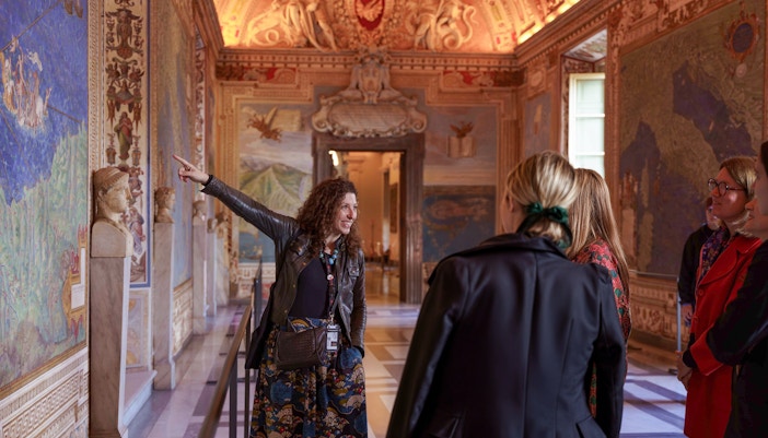 Guide leading tour group through Gallery of Maps, Vatican Museum.