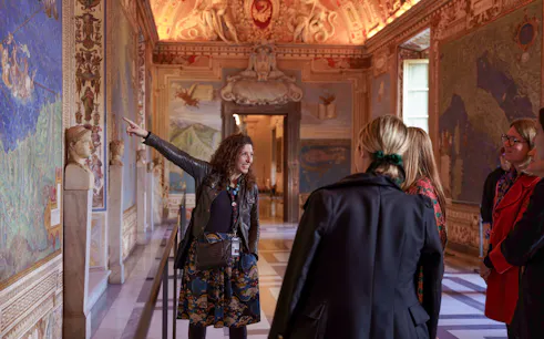 Guide leading tour group through Gallery of Maps, Vatican Museum.