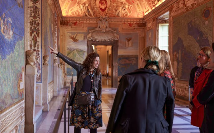 Guide leading tour group through Gallery of Maps, Vatican Museum.