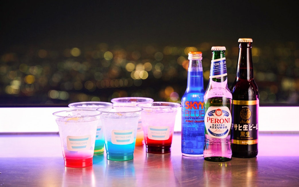 Drinks on a table with a city night view from Tembo Deck.