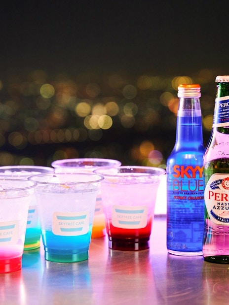 Drinks on a table with a city night view from Tembo Deck.