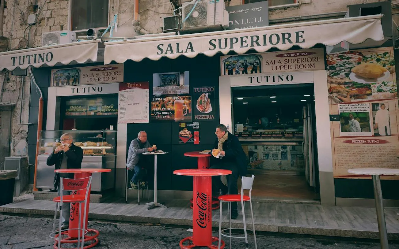 Outdoor seating at Tutino pizzeria in Naples, part of the Curse of Naples Mafia Secrets tour.