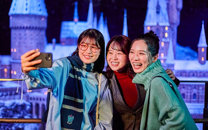 Visitors taking a selfie with the Hogwarts castle model at The Making of Harry Potter Studio Tour, Tokyo.