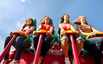 Visitors enjoying the Leviathan roller coaster at Canada's Wonderland under a clear blue sky.