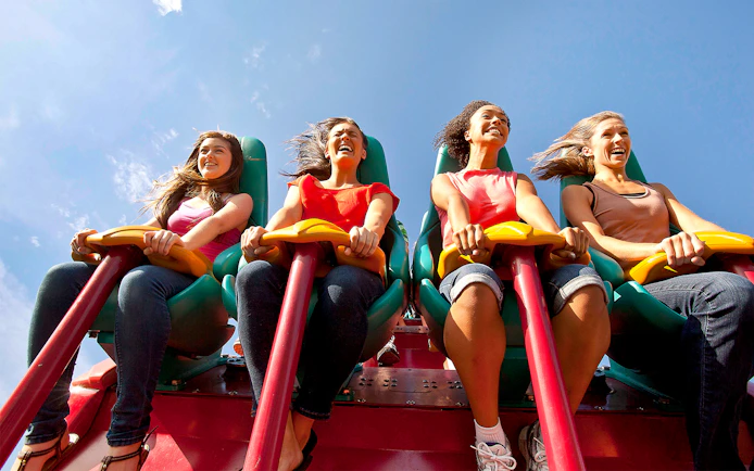 Visitors enjoying the Leviathan roller coaster at Canada's Wonderland under a clear blue sky.