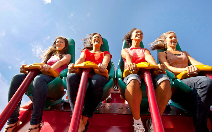Visitors enjoying the Leviathan roller coaster at Canada's Wonderland under a clear blue sky.