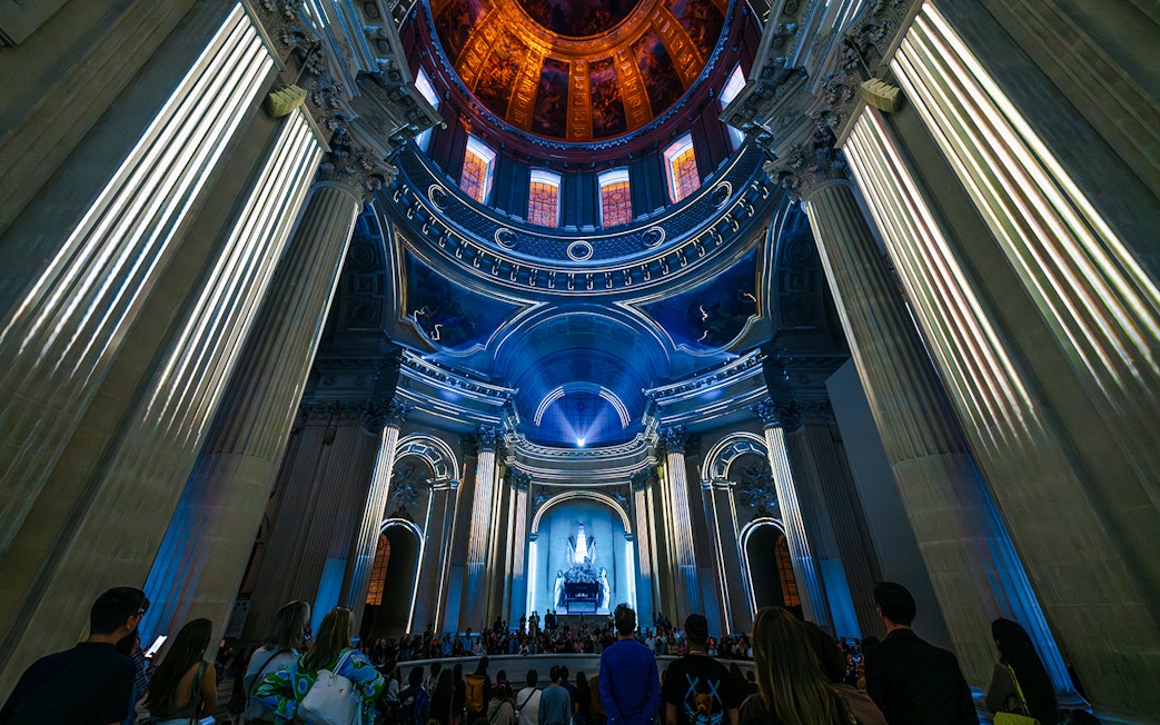 People experiencing Aura Immersive light show at Invalides, Paris.