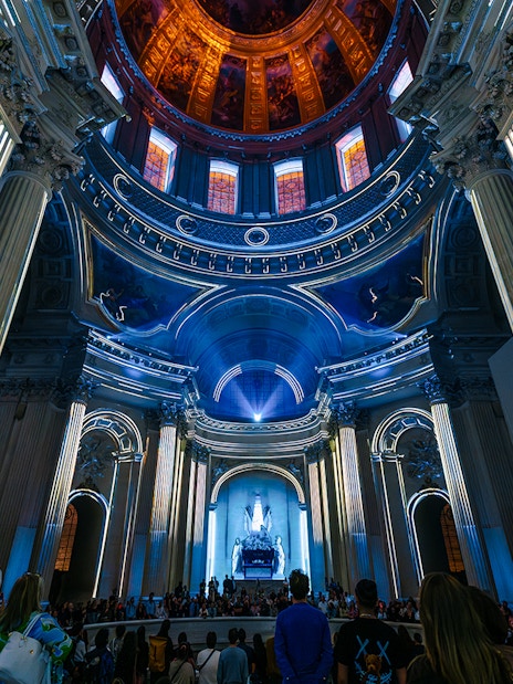 People experiencing Aura Immersive light show at Invalides, Paris.