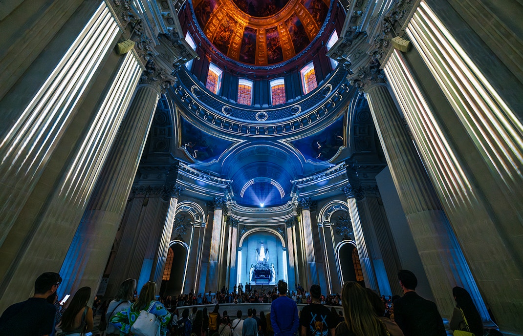 People experiencing Aura Immersive light show at Invalides, Paris.