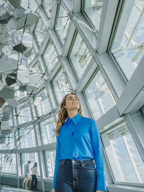 Person inside Glories Skyline Tower with geometric ceiling design.
