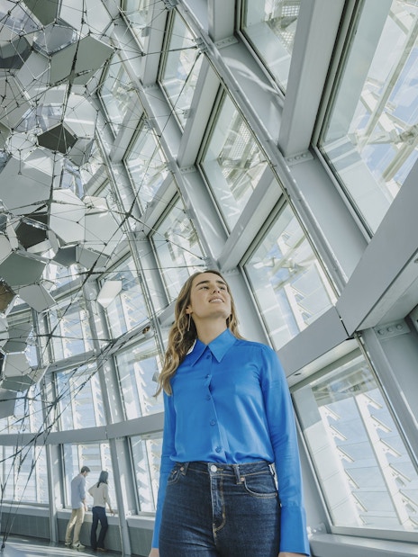 Person inside Glories Skyline Tower with geometric ceiling design.