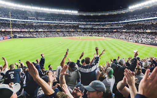 Fans cheering at Yankee Stadium during New York Yankees vs Boston Red Sox game, June 10, 2023.