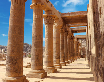 Pillars and passage inside Philae Temple, Aswan, Egypt, showcasing ancient Egyptian architecture.