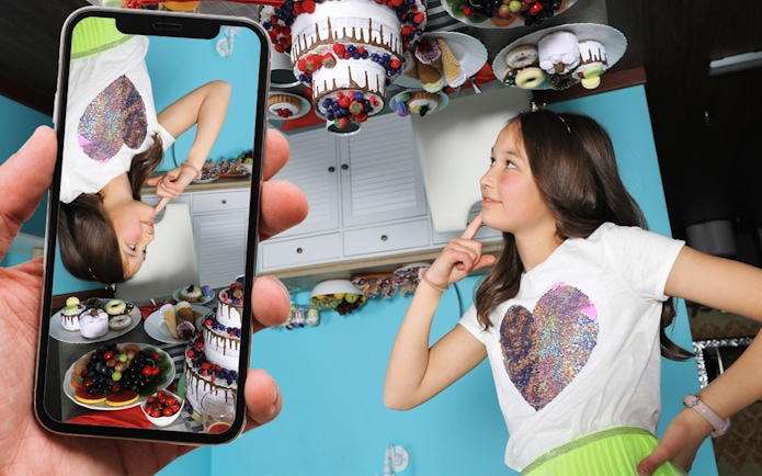 Girl in a room with upside-down desserts at the Big Fun Museum.