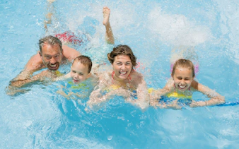 Family enjoying splash pool at Wet 'n' Wild water park.