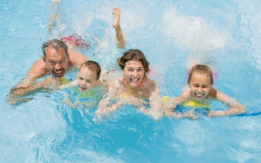 Family enjoying splash pool at Wet 'n' Wild water park.