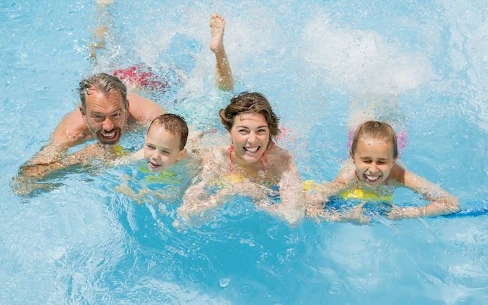 Family enjoying splash pool at Wet 'n' Wild water park.