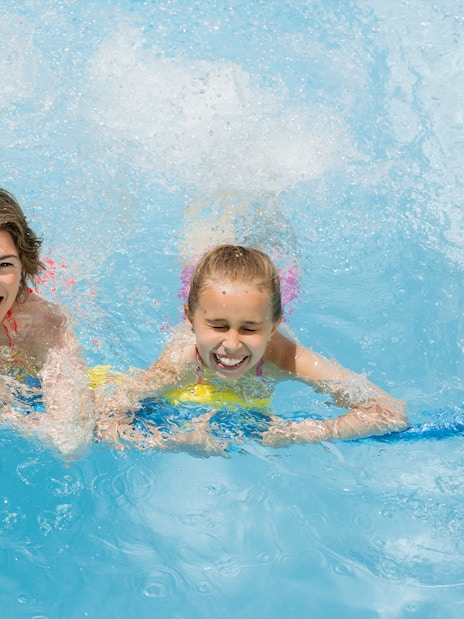 Family enjoying splash pool at Wet 'n' Wild water park.