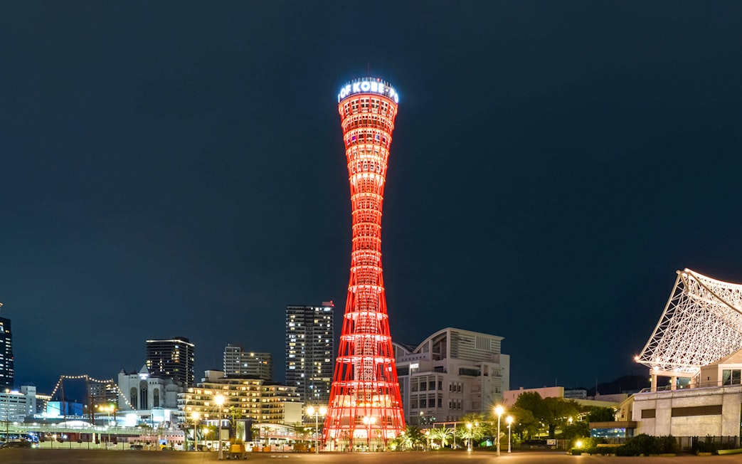 Kobe Port Tower illuminated at night in Kobe, Japan.