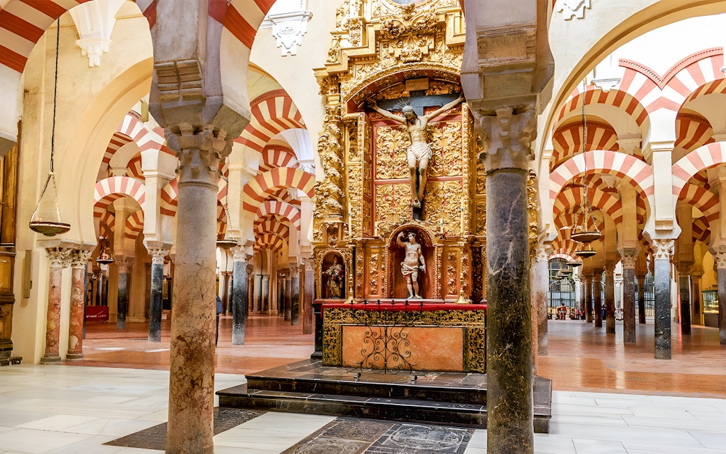 Jesus altar inside Cordoba Cathedral and Mosque with ornate arches and columns.