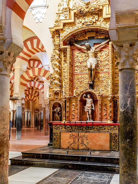Jesus altar inside Cordoba Cathedral and Mosque with ornate arches and columns.