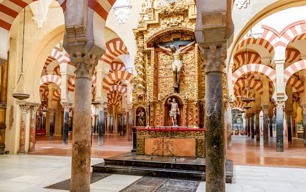 Jesus altar inside Cordoba Cathedral and Mosque with ornate arches and columns.