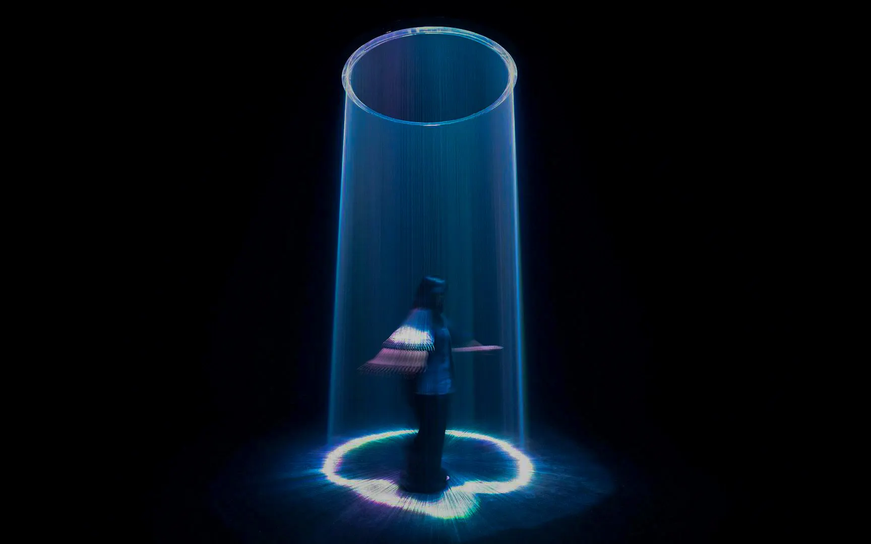 Visitor interacting with light sculpture at Singapore's ArtScience Museum.