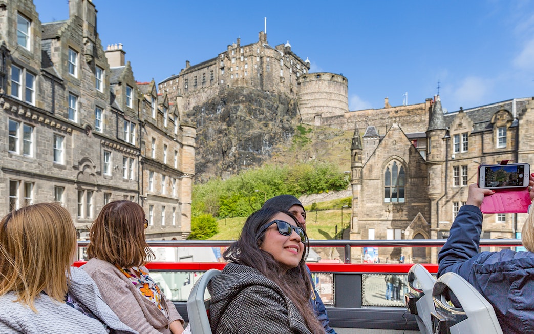 Tourists on HOHO bus near Edinburgh Castle, Scotland.
