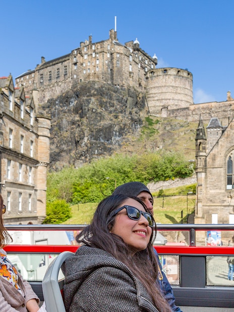 Tourists on HOHO bus near Edinburgh Castle, Scotland.