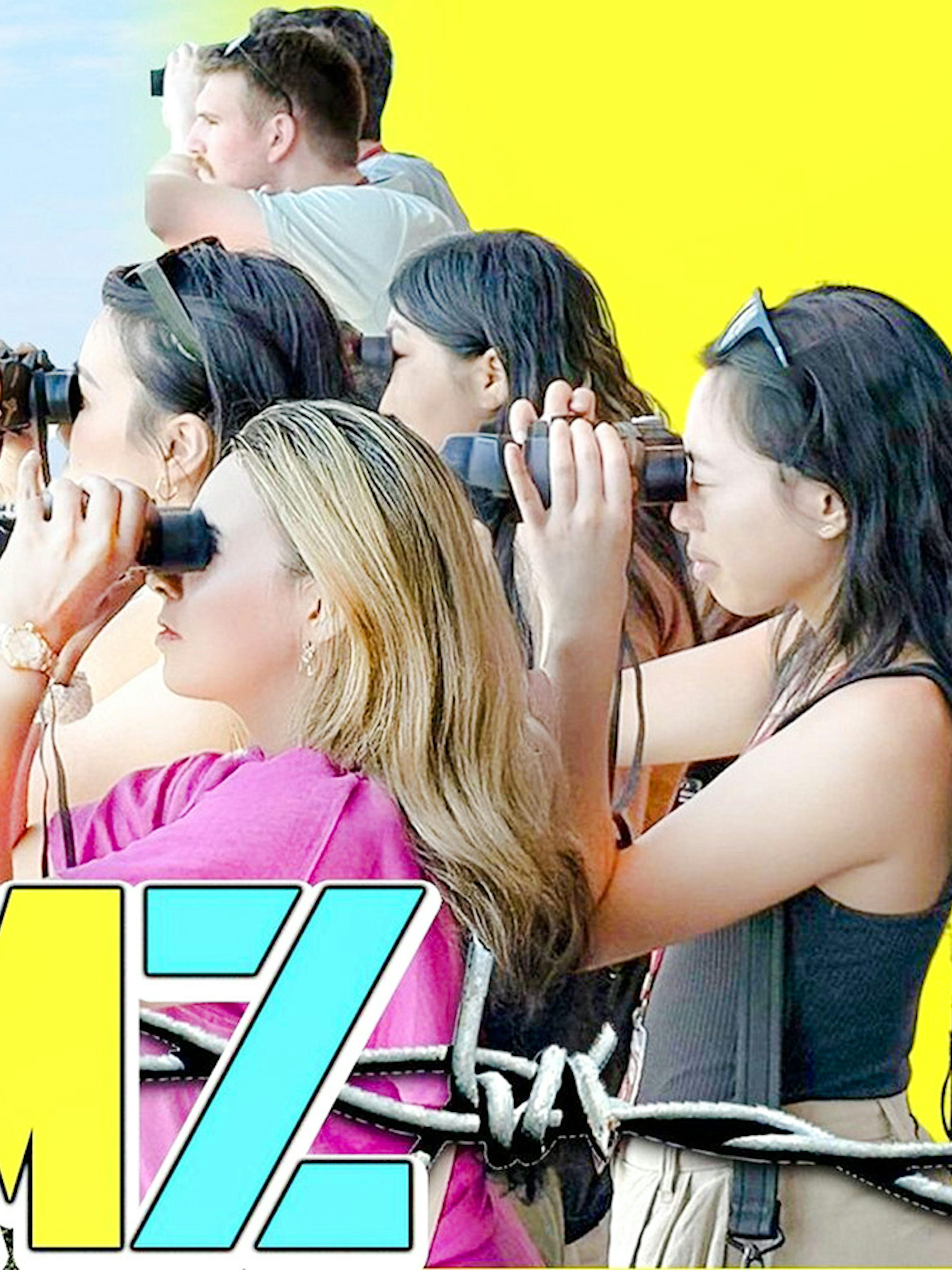 Tour group at DMZ observatory using binoculars to view North Korean village and flag.