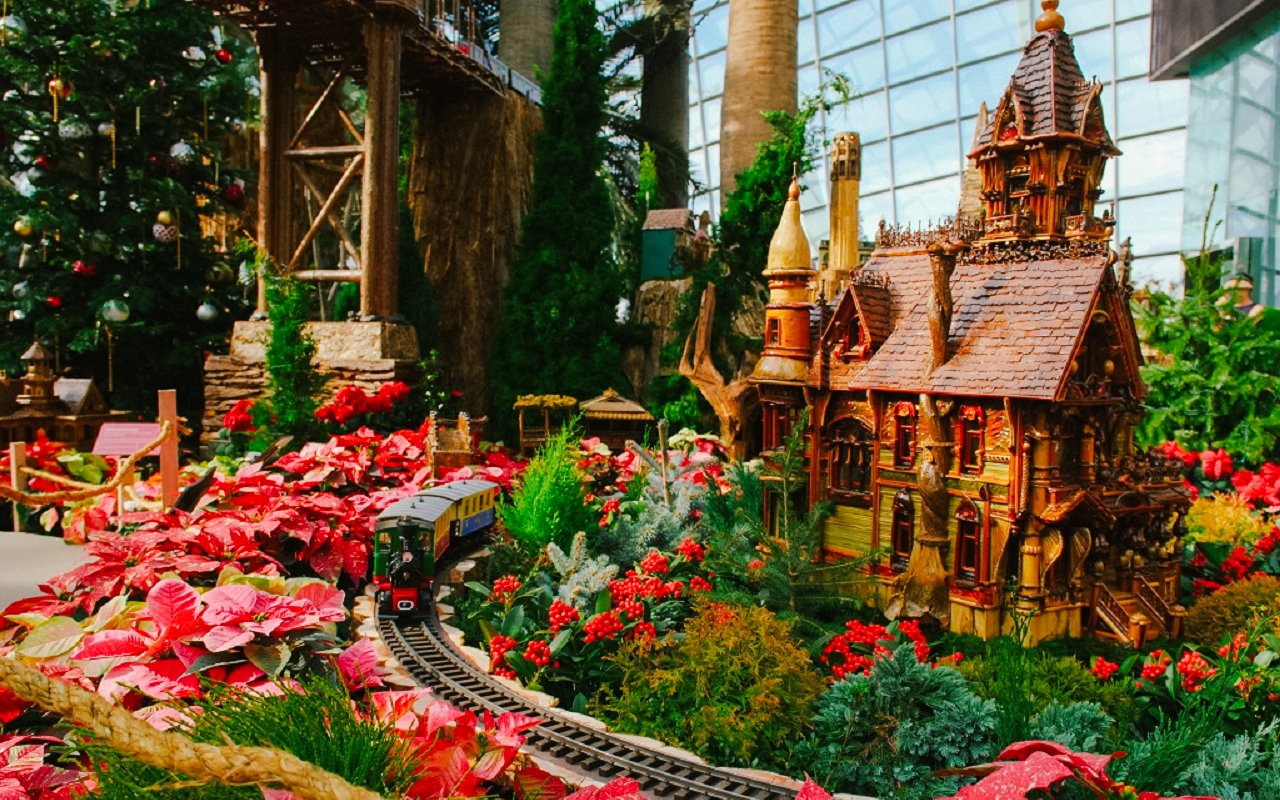Christmas train display at Gardens by the Bay with festive decorations and model house.