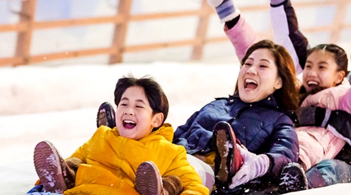 Children enjoying a snow slide at Snow City.