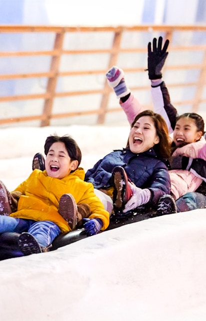 Children enjoying a snow slide at Snow City.