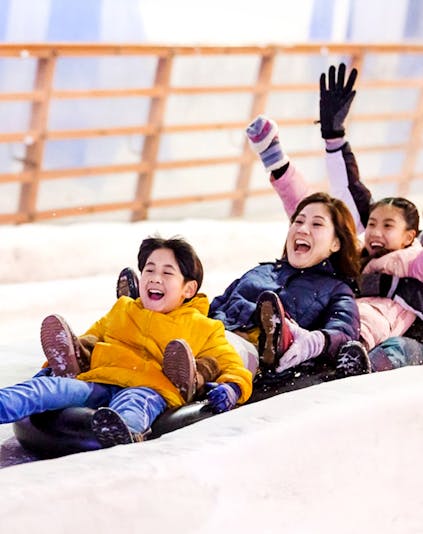 Visitors enjoying snow activities at Snow City indoor park, Singapore.