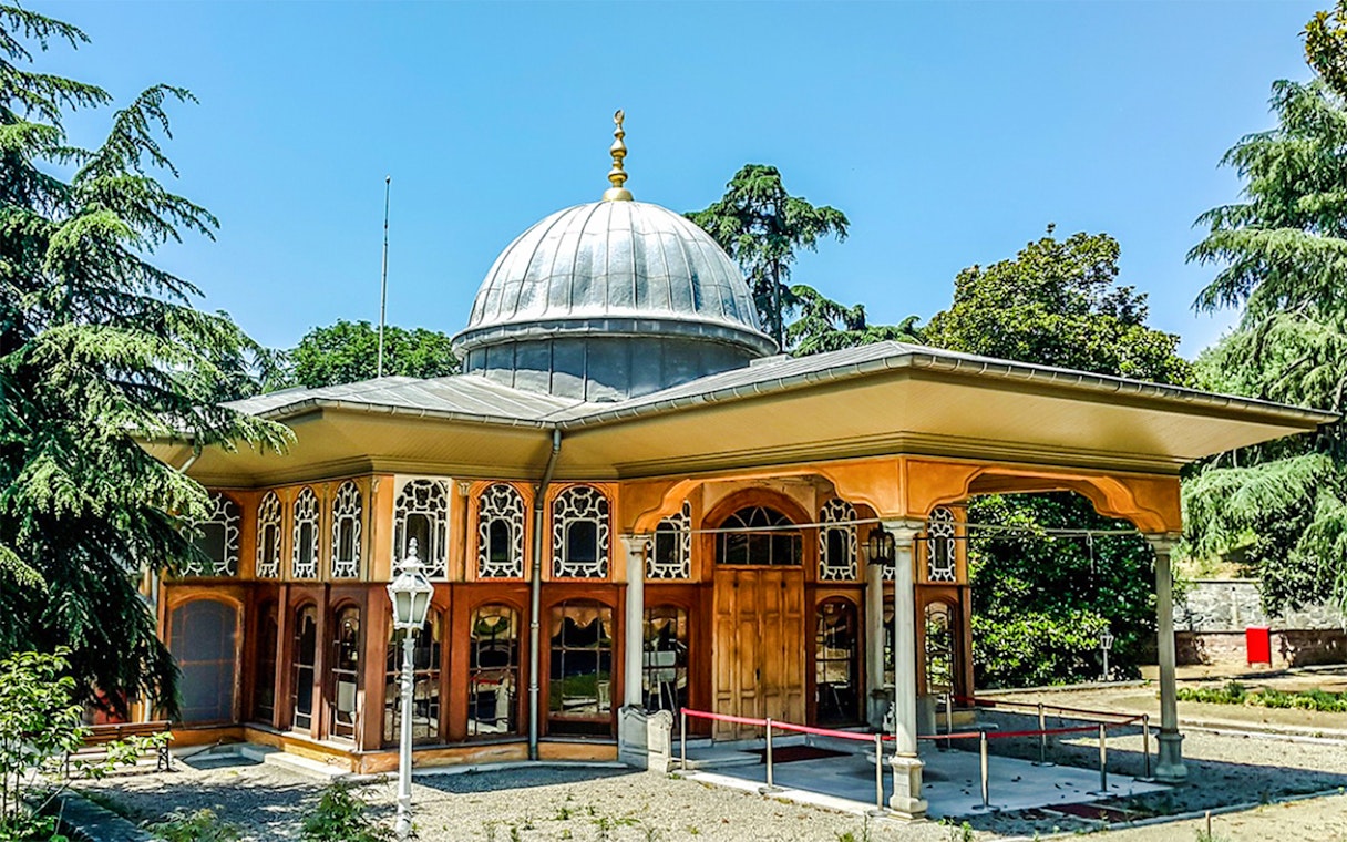 Aynalıkavak Pavilion with ornate windows and dome, surrounded by trees in Istanbul.