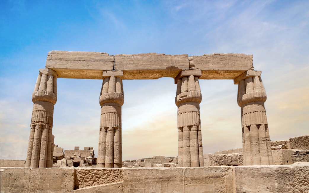 Karnak Temple columns under a clear sky in Luxor, Egypt.
