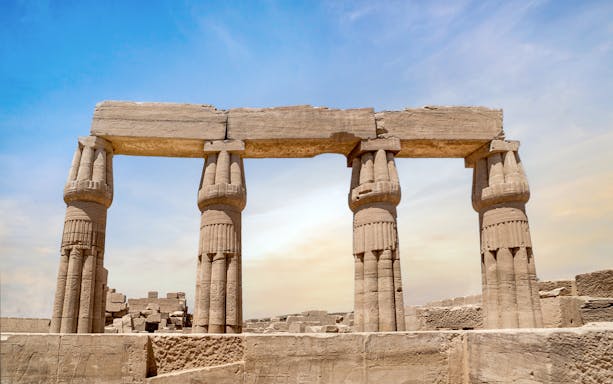 Karnak Temple columns under a clear sky in Luxor, Egypt.