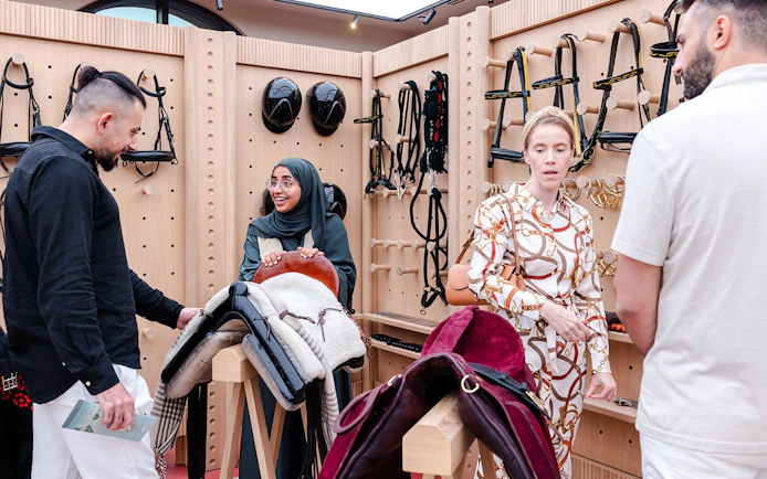 Visitors exploring equestrian gear at Abu Dhabi Royal Equestrian Arts guided tour.