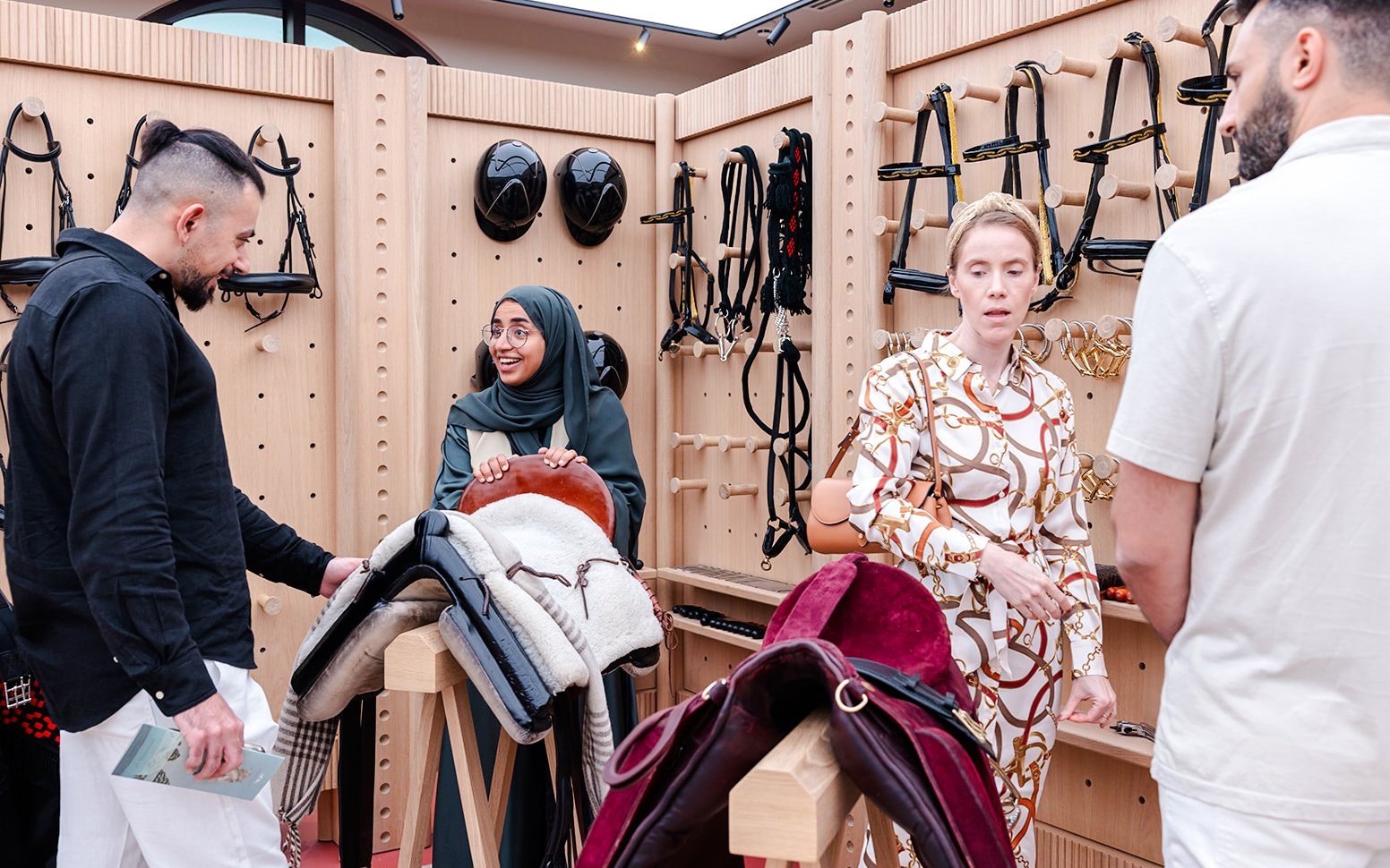 Visitors exploring equestrian gear at Abu Dhabi Royal Equestrian Arts guided tour.