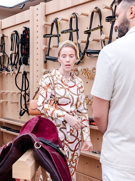 Visitors exploring equestrian gear at Abu Dhabi Royal Equestrian Arts guided tour.