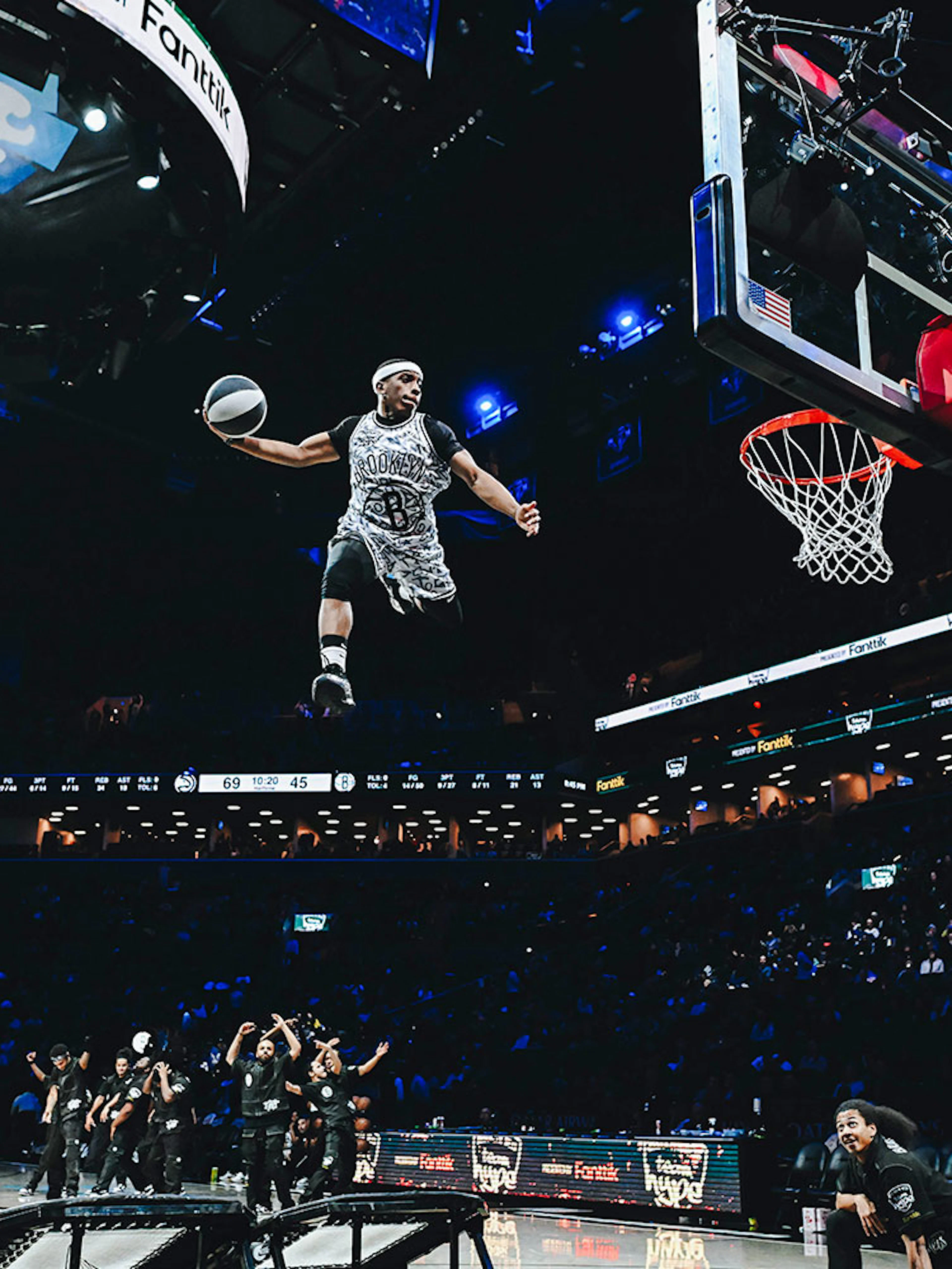 Basketball player performing a slam dunk at Barclays Center, home of the Brooklyn Nets.