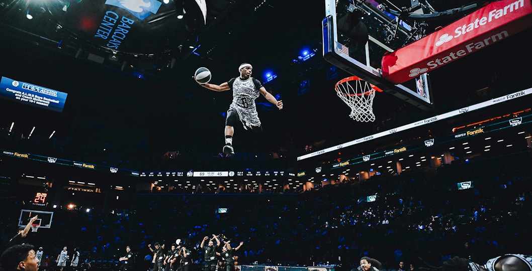 Basketball player performing a slam dunk at Barclays Center, home of the Brooklyn Nets.