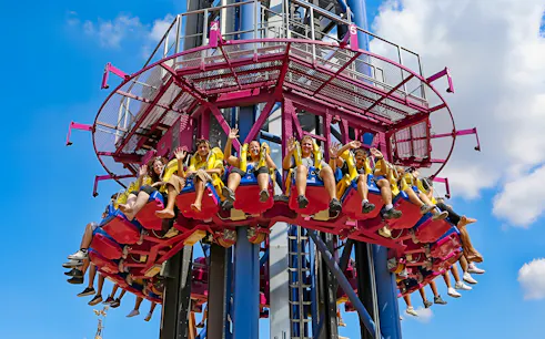 Thrill-seekers on a drop tower ride at MagicLand Amusement Park.