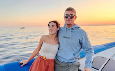 Couple enjoying sunset on a boat tour to Villefranche and Mala Cove.