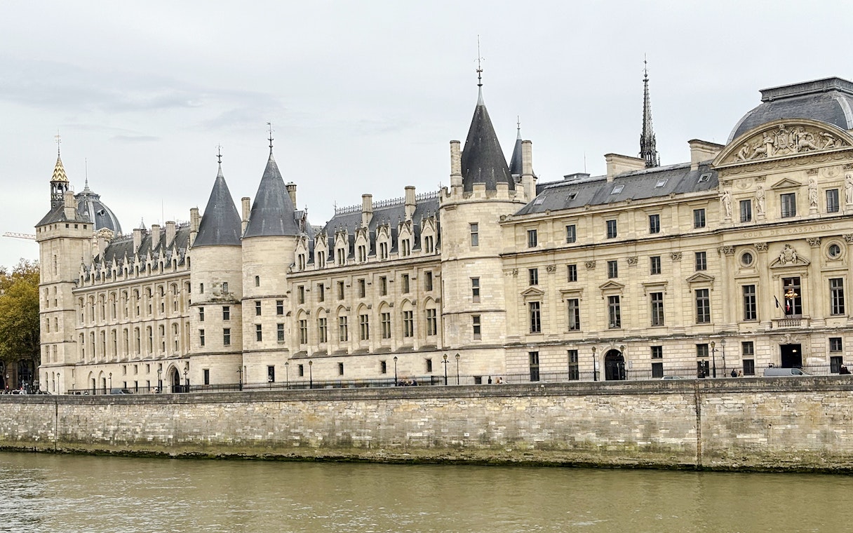 Conciergerie building along the Seine River in Paris, part of the Treasure Hunt tour from the Panthéon to the Louvre.
