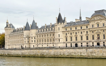 Conciergerie building along the Seine River in Paris, part of the Treasure Hunt tour from the Panthéon to the Louvre.